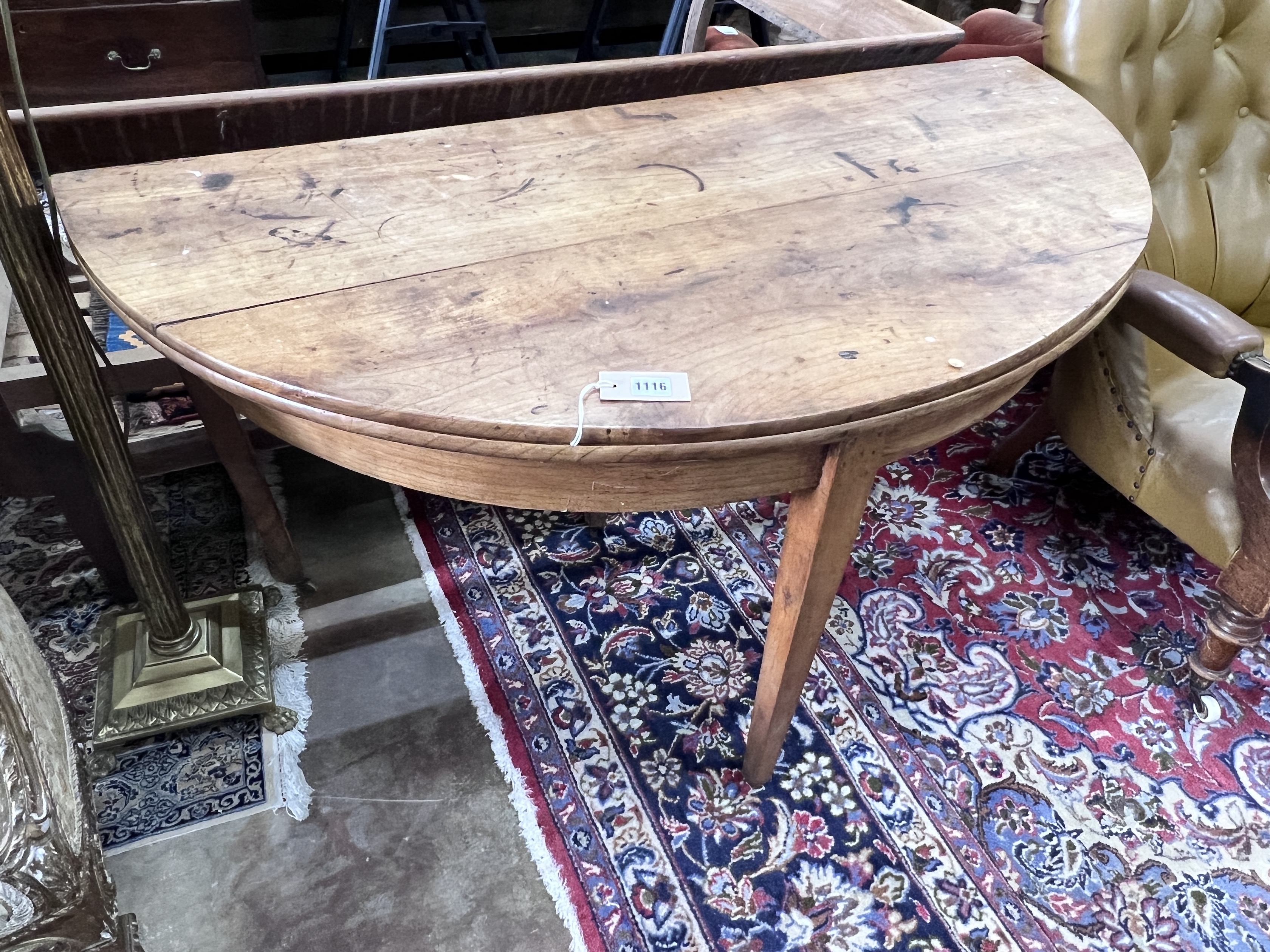 An early 19th century continental fruitwood D shaped folding tea table, width 124cm, depth 60cm, height 73cm